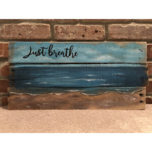 Just Breathe Sign Board on Wall