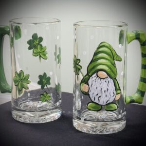 Gnome and shamrocks painted on glass mugs.