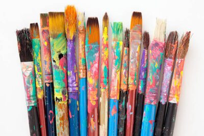 Several dirty brushes over white background